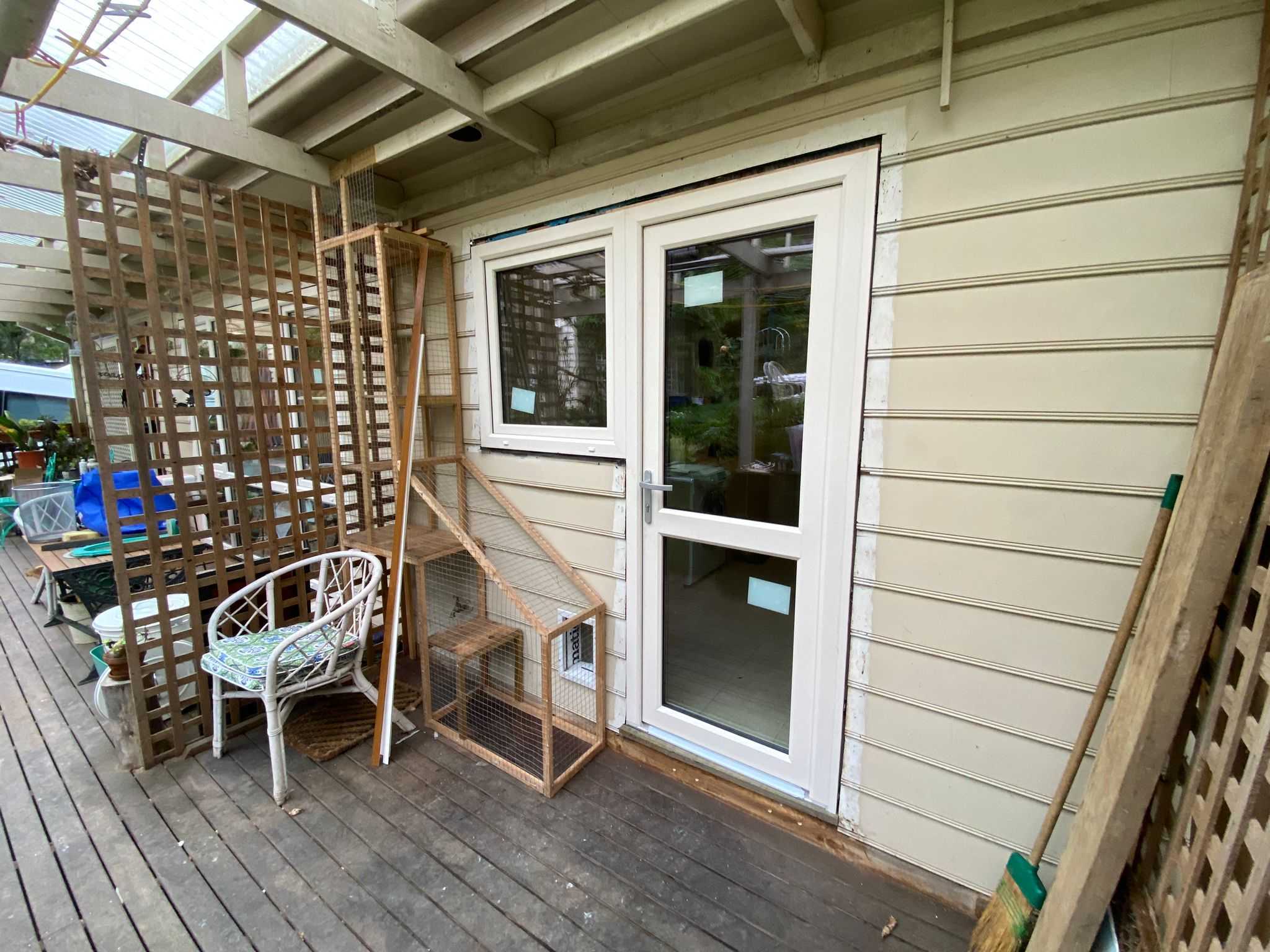 cream coloured hinged door and tilt and turn window at the entrance of the house