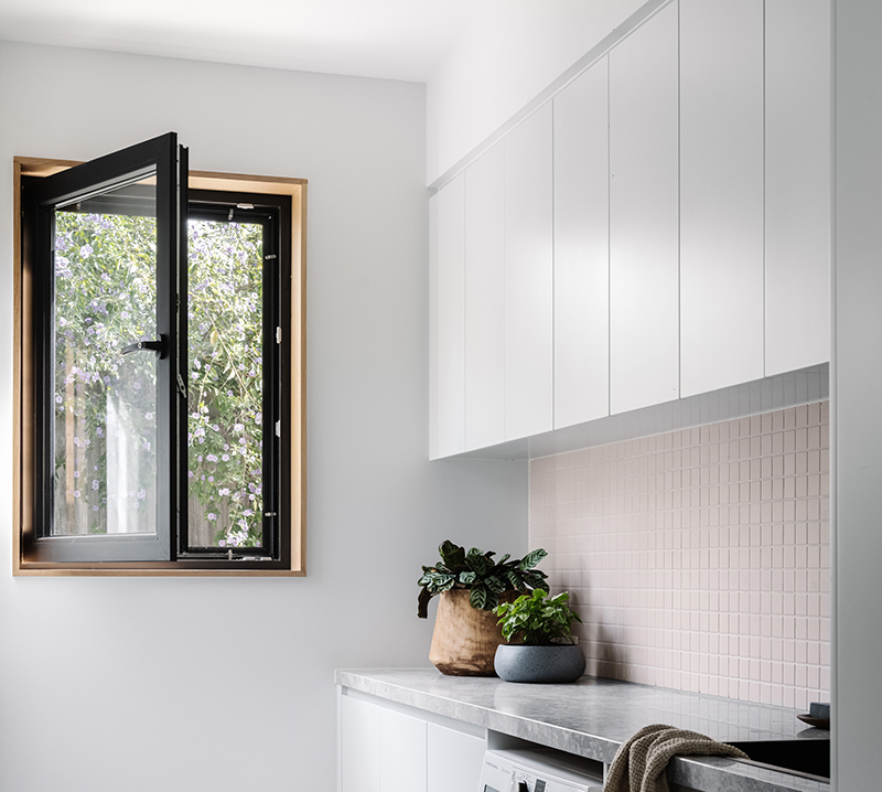 Smooth Black Tilt and Turn window of bathroom of a passive house in Yarra St Melbourne