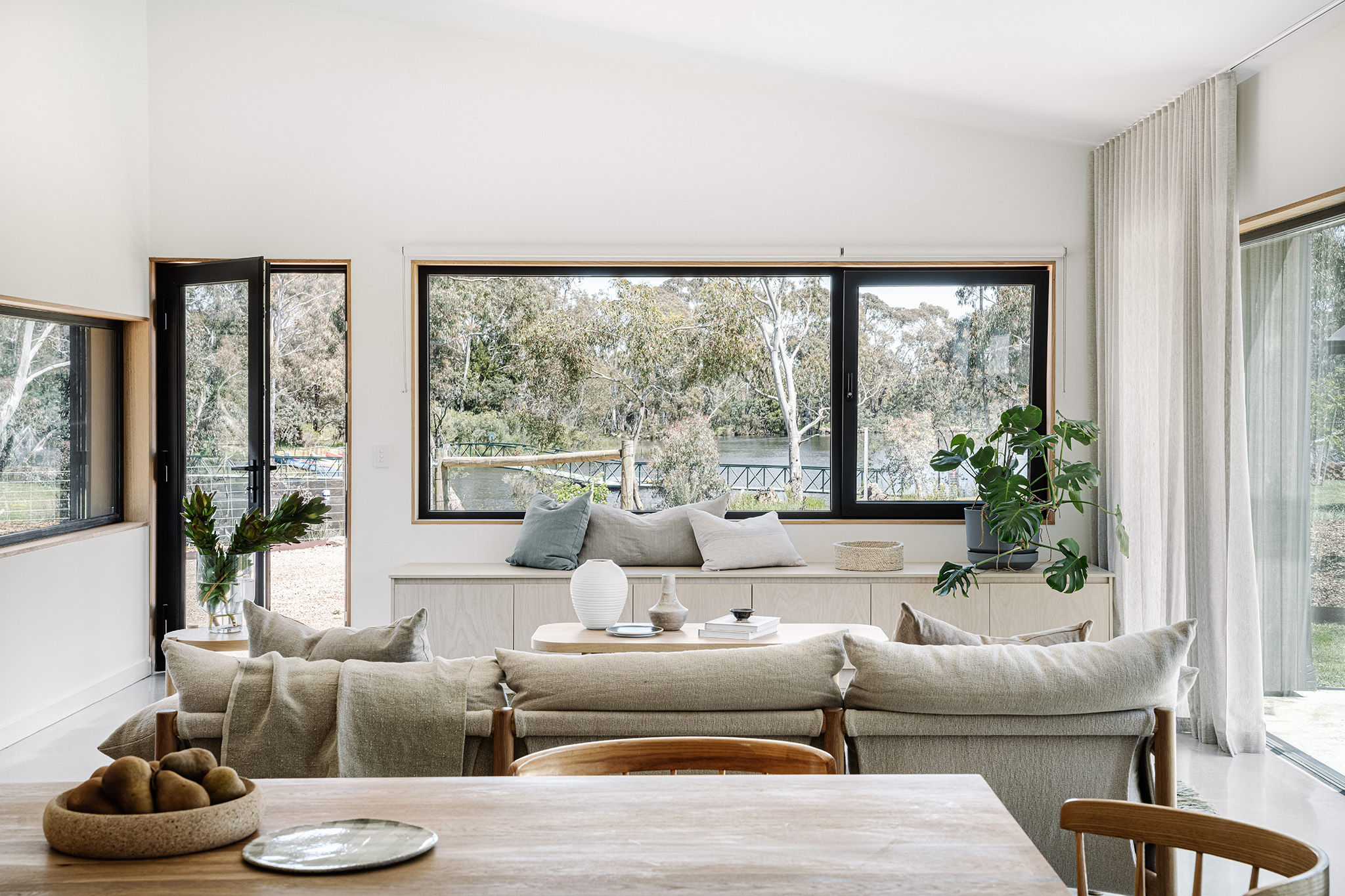 View of living room in a passive house with Smooth Black Tilt and Turn Window and Hinged Door in Kyneton